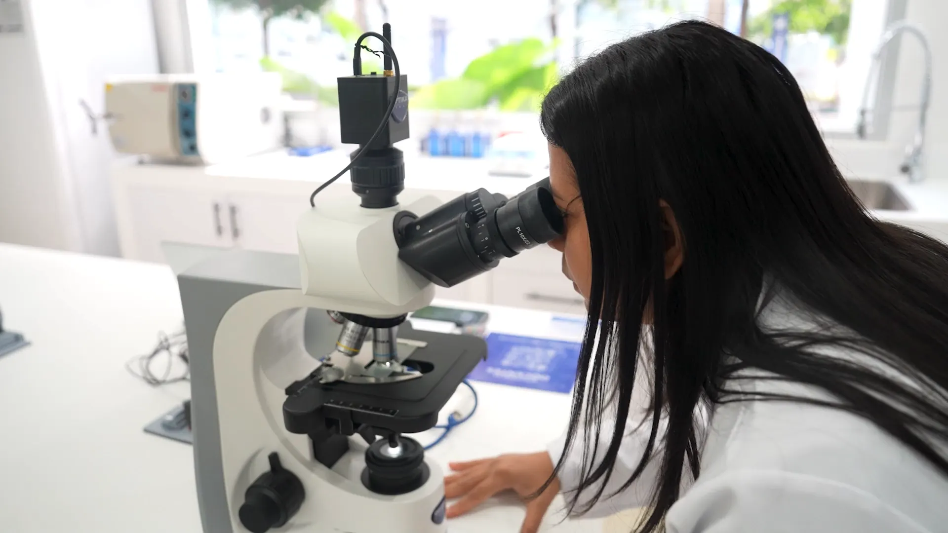 ECOTEC researcher analyzing samples under a microscope