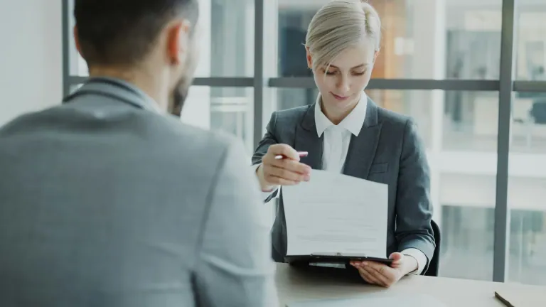 A lawyer reviews a document with a client during a legal consultation