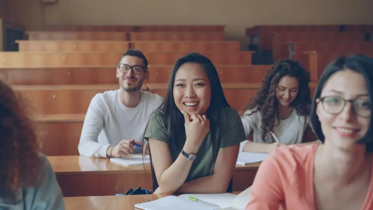 Smiling students in a university classroom